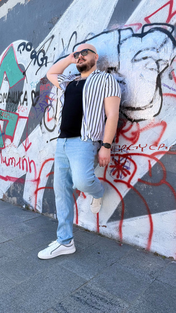 Urban Street Style Menswear: Striped Shirt & Denim Outfit and Styling Ideas on Graffiti Backdrop
