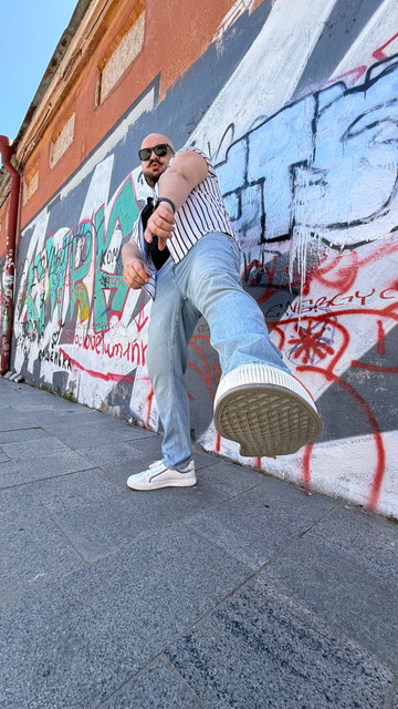 Urban Street Style Menswear: Striped Shirt & Denim Outfit and Styling Ideas on Graffiti Backdrop