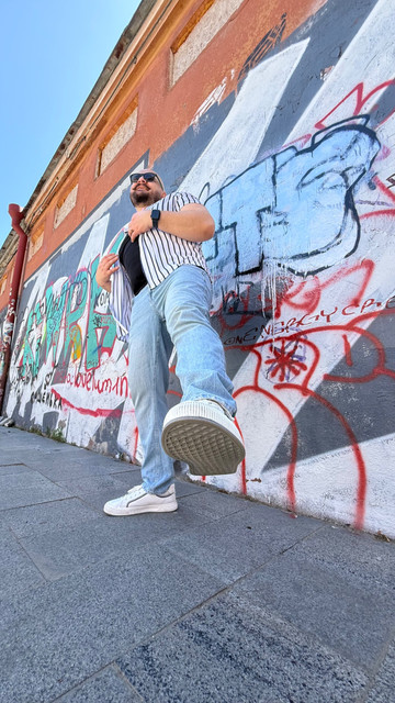 Urban Street Style Menswear: Striped Shirt & Denim Outfit and Styling Ideas on Graffiti Backdrop