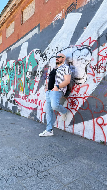Urban Street Style Menswear: Striped Shirt & Denim Outfit and Styling Ideas on Graffiti Backdrop